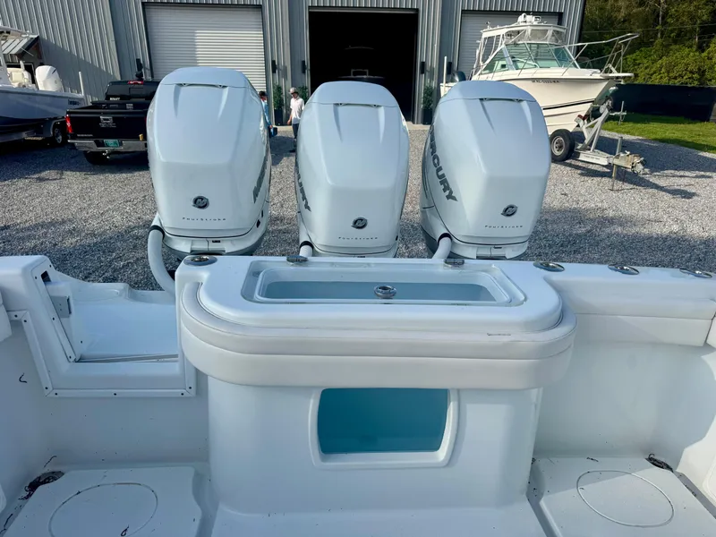 Slide: The Image of 2022 Yellowfin 36 Open boat with triple Mercury engines and livewell, parked outdoors. - 8