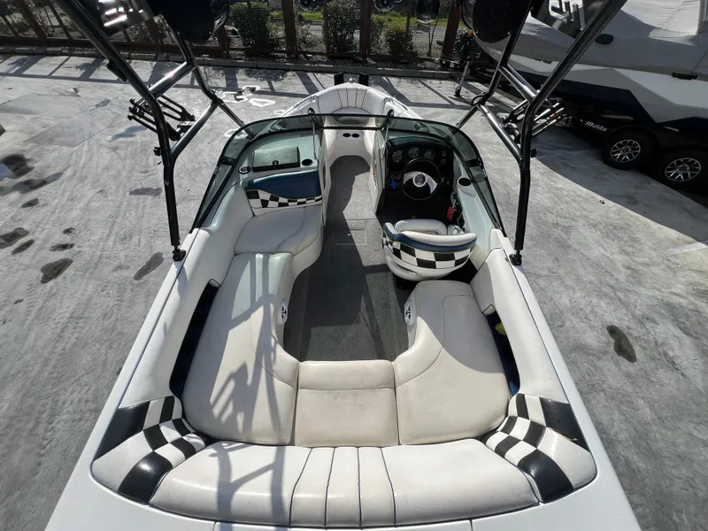 Slide: The Image of 2002 MB B52 boat interior with white seating and checkered accents. - 11