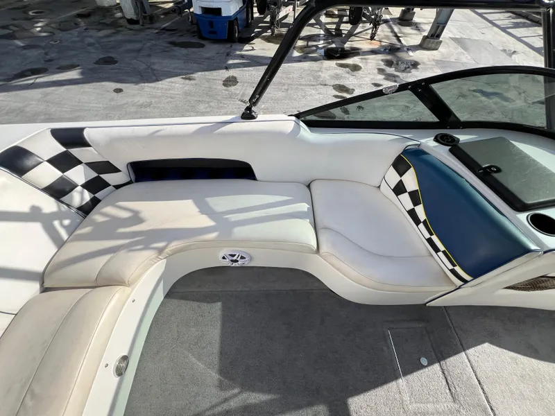 Slide: The Image of Interior of a 2002 MB B52 boat with checkered upholstery and seating. - 12