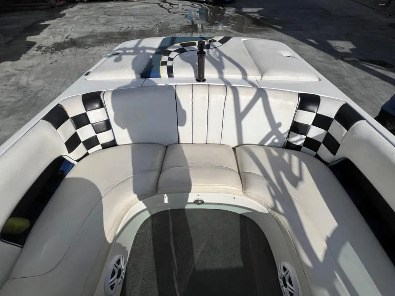 Slide: The Image of Interior of 2002 MB B52 boat with checkered upholstery and seating area. - 13