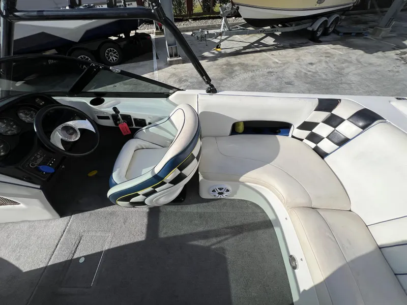 Slide: The Image of Interior of a 2002 MB B52 boat with checkered seating and steering wheel. - 14