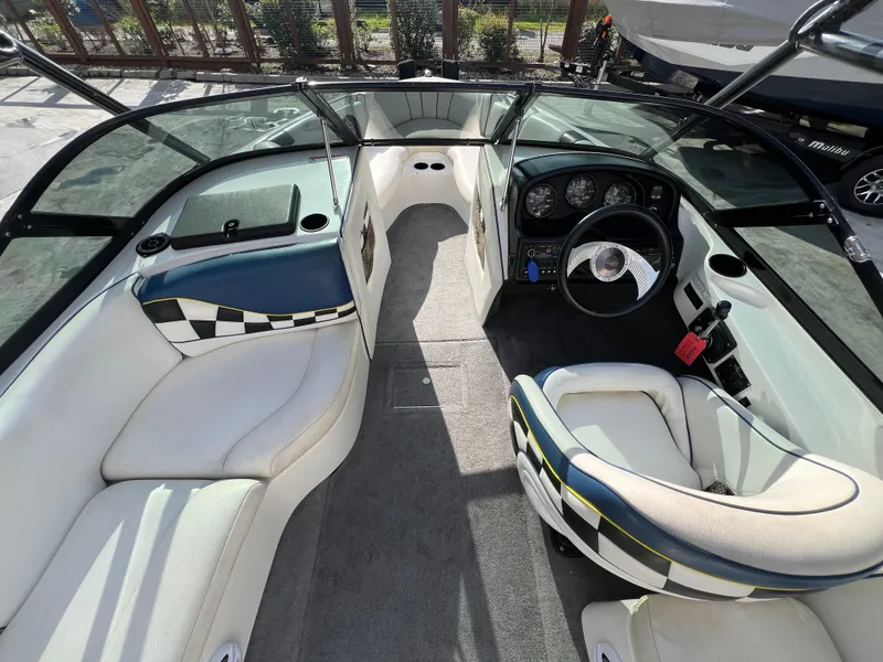 Slide: The Image of Interior of a 2002 MB B52 boat with stylish seating and dashboard. - 15