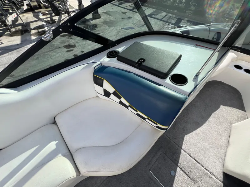 Slide: The Image of Interior of a 2002 MB B52 boat with white seating and checkered design. - 16