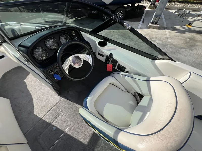 Slide: The Image of Interior of a 2002 MB B52 boat showing steering wheel and dashboard controls. - 17