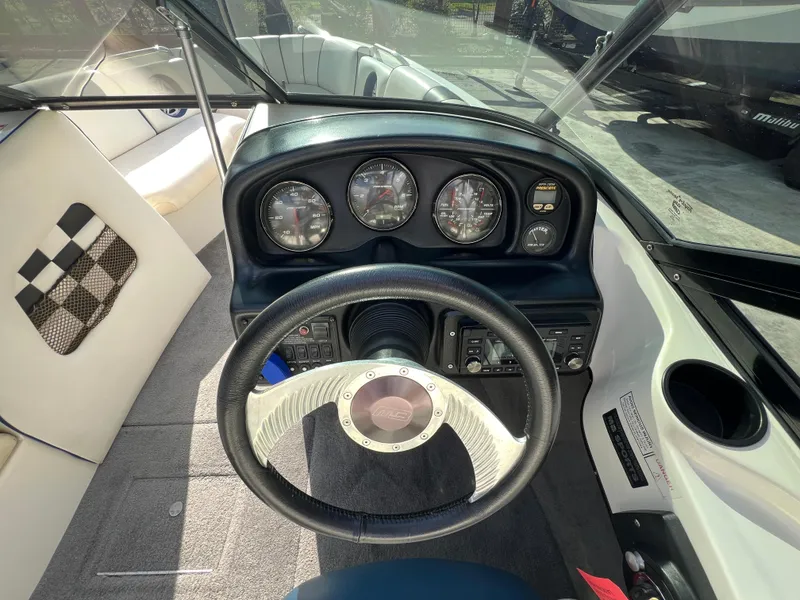 Slide: The Image of 2002 MB B52 boat dashboard with steering wheel and instrument gauges. - 18
