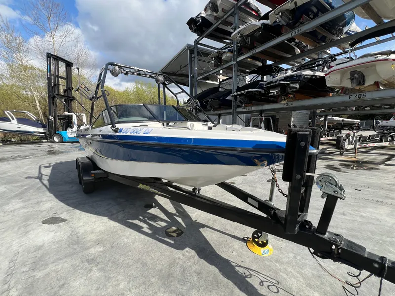 Slide: The Image of 2002 MB B52 boat on trailer in marina storage area. - 4