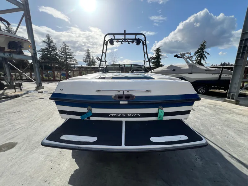 Slide: The Image of 2002 MB B52 boat on a sunny day, parked on a concrete surface. - 7