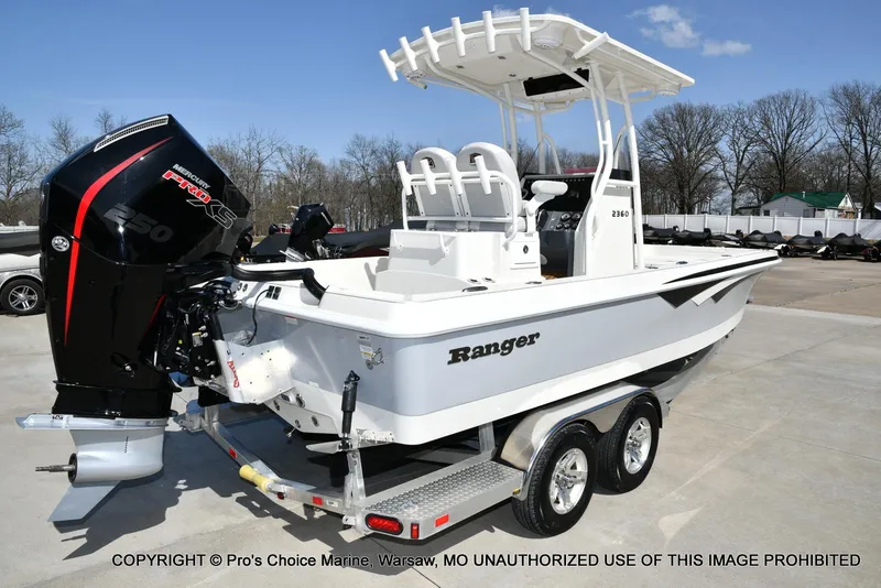 Slide: The Image of 2023 Ranger 2360 Bay boat on trailer with Mercury Pro XS engine, parked outdoors. - 11