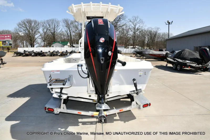 Slide: The Image of 2023 Ranger 2360 Bay boat with outboard motor on a trailer in a marina. - 16