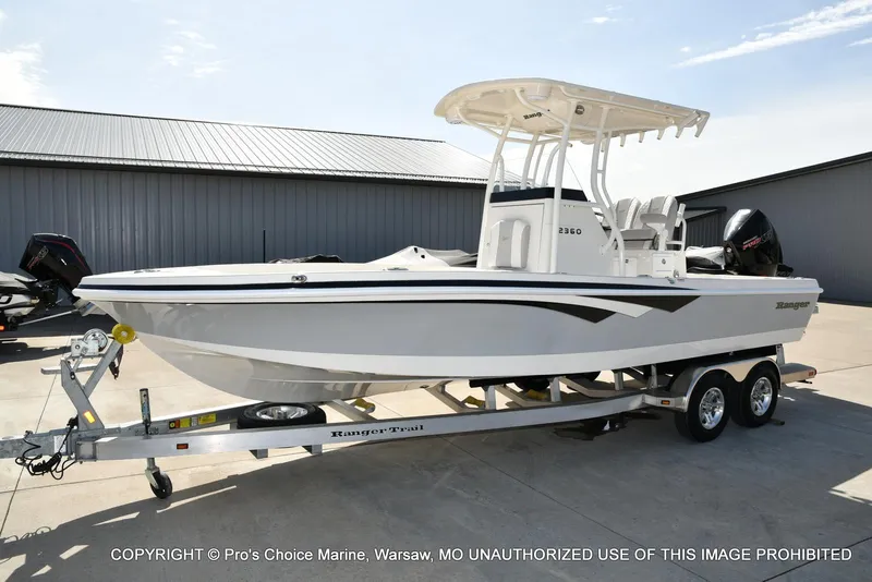 Slide: The Image of 2023 Ranger 2360 Bay boat on trailer, parked outdoors. - 19