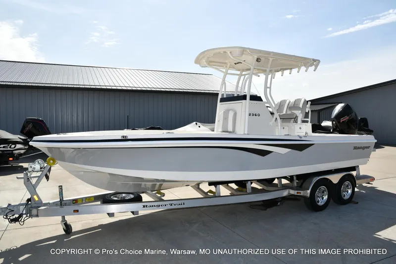 Slide: The Image of 2023 Ranger 2360 Bay boat on trailer, parked outdoors. - 20