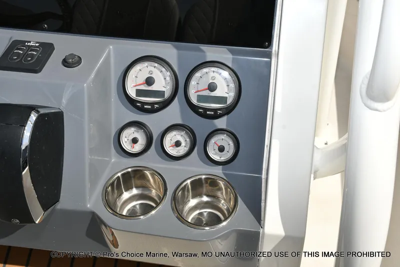 Slide: The Image of 2023 Ranger 2360 Bay boat dashboard with gauges and cup holders. - 32