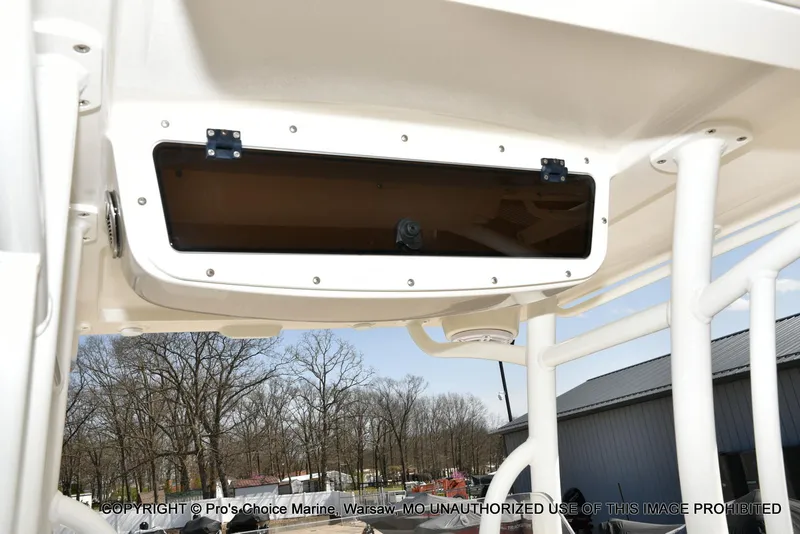 Slide: The Image of 2023 Ranger 2360 Bay boat console storage compartment with tinted cover. - 35