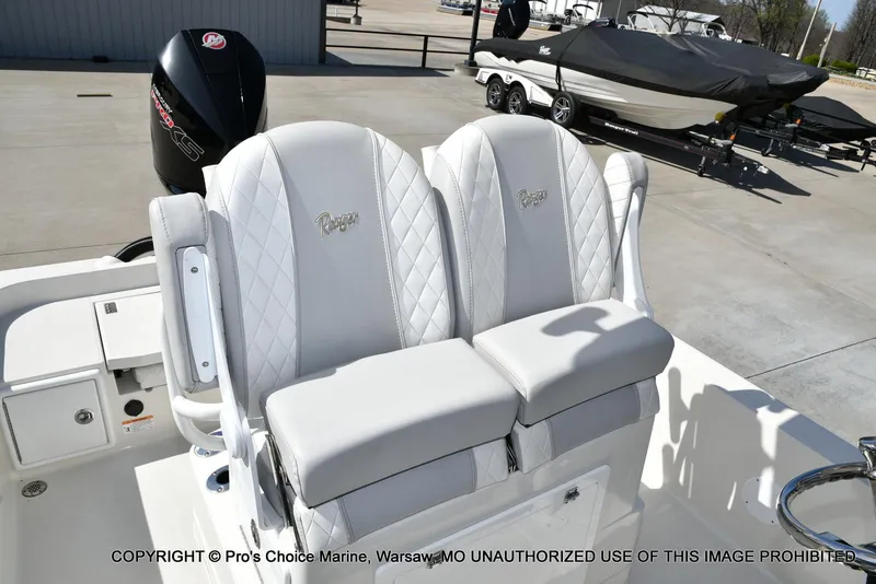 Slide: The Image of 2023 Ranger 2360 Bay boat with dual white cushioned seats and Mercury engine. - 39