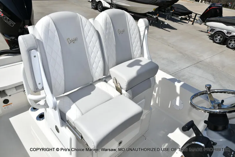 Slide: The Image of 2023 Ranger 2360 Bay boat with white leather seats and steering wheel. - 40