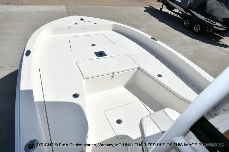 Slide: The Image of 2023 Ranger 2360 Bay boat deck with storage compartments, displayed outdoors. - 41