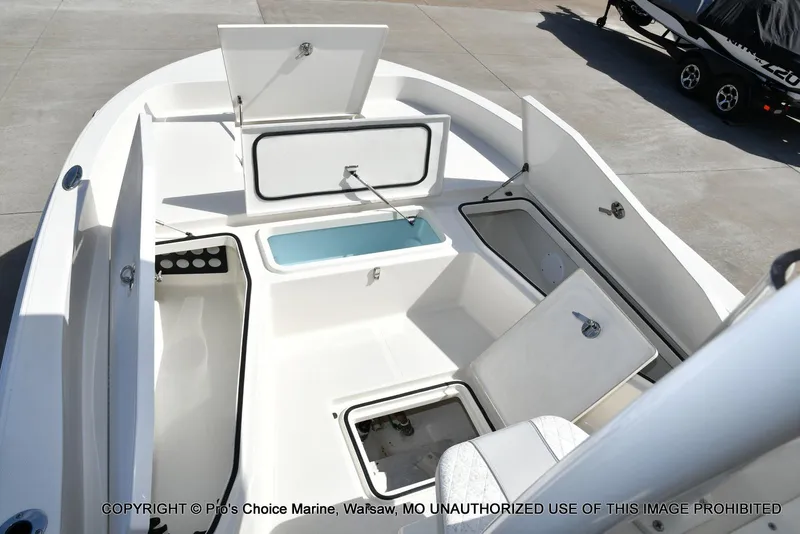 Slide: The Image of 2023 Ranger 2360 Bay boat interior with open storage compartments and seating. - 43
