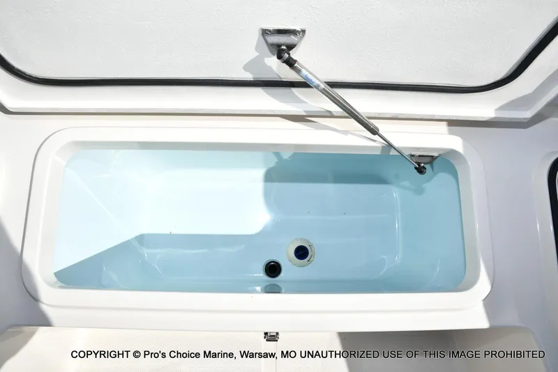 Slide: The Image of 2023 Ranger 2360 Bay boat livewell with open lid and hydraulic support. - 47
