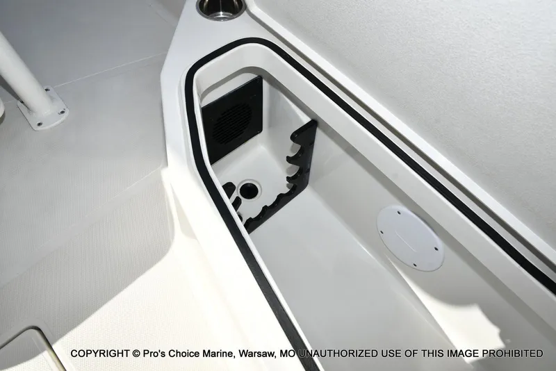 Slide: The Image of 2023 Ranger 2360 Bay boat storage compartment with rod holders and drainage system. - 49