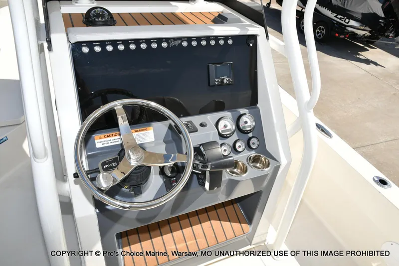 Slide: The Image of 2023 Ranger 2360 Bay boat dashboard with steering wheel and controls. - 5