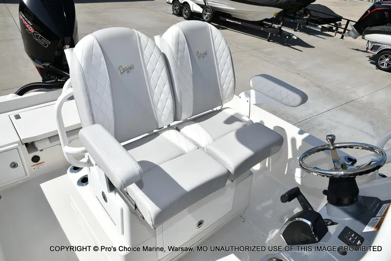 Slide: The Image of 2023 Ranger 2360 Bay boat with dual white cushioned seats and steering wheel. - 6