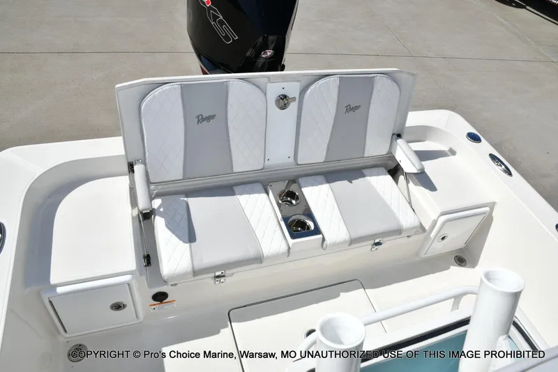 Slide: The Image of 2023 Ranger 2360 Bay boat seating area with cup holders and storage compartments. - 8