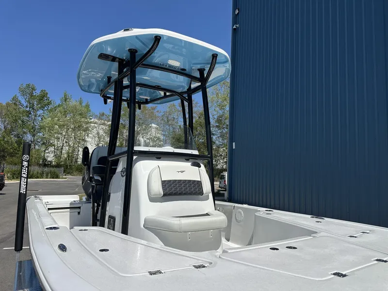 Slide: The Image of 2025 Tidewater 2110 Bay Max boat with T-top, parked outdoors. - 11