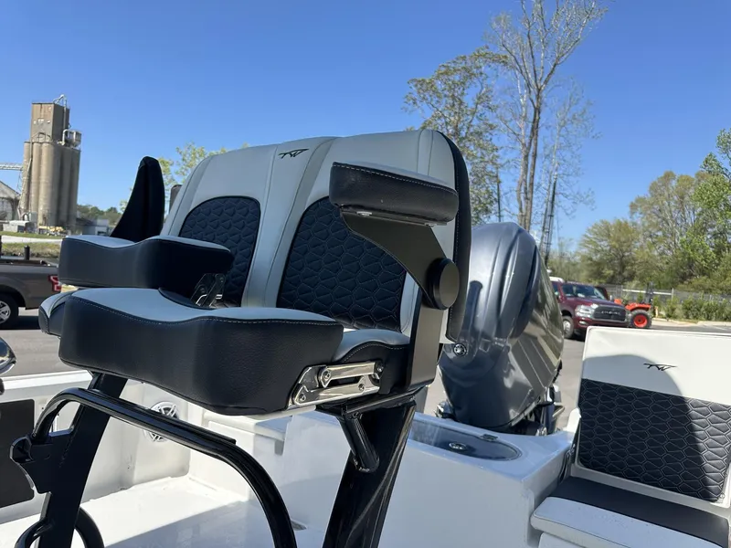 Slide: The Image of 2025 Tidewater 2110 Bay Max boat seat and engine, outdoor setting. - 9