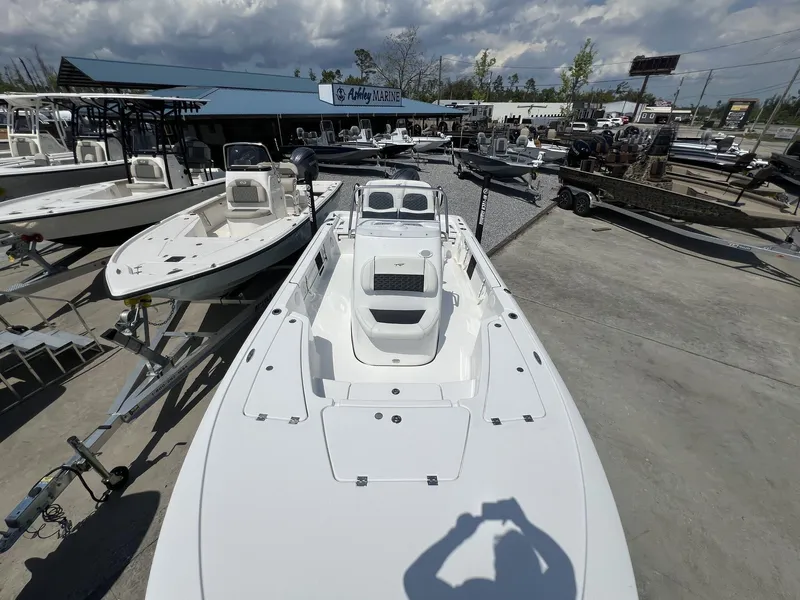 Slide: The Image of 2025 Tidewater 2110 Bay Max boat displayed at a marina with other boats. - 14