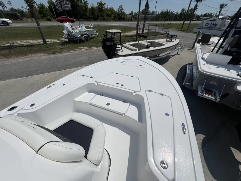 Slide: The Image of 2025 Tidewater 2110 Bay Max boat displayed outdoors, showcasing sleek design and spacious deck. - 15