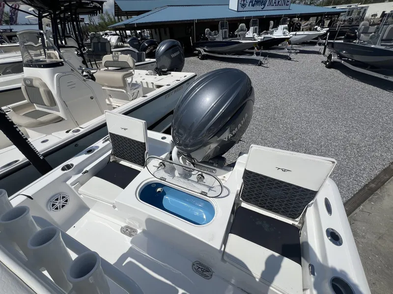 Slide: The Image of 2025 Tidewater 2110 Bay Max boat with Yamaha engine at a marine dealership. - 5
