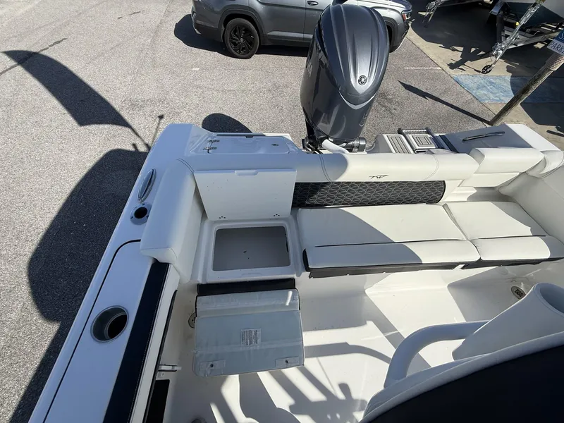 Slide: The Image of 2025 Tidewater 220 LXF boat interior with seating and outboard motor. - 13