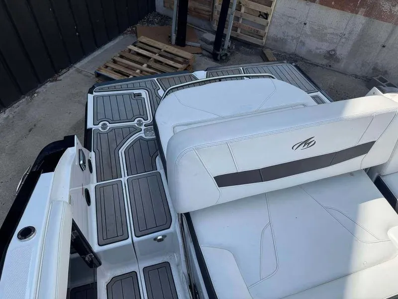 Slide: The Image of 2015 Monterey 258SS boat interior with white seating and gray decking. - 3