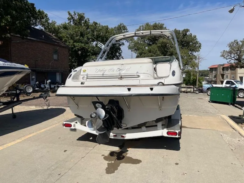 Slide: The Image of 2004 Crownline 230BR boat on trailer, parked outdoors, rear view. - 3