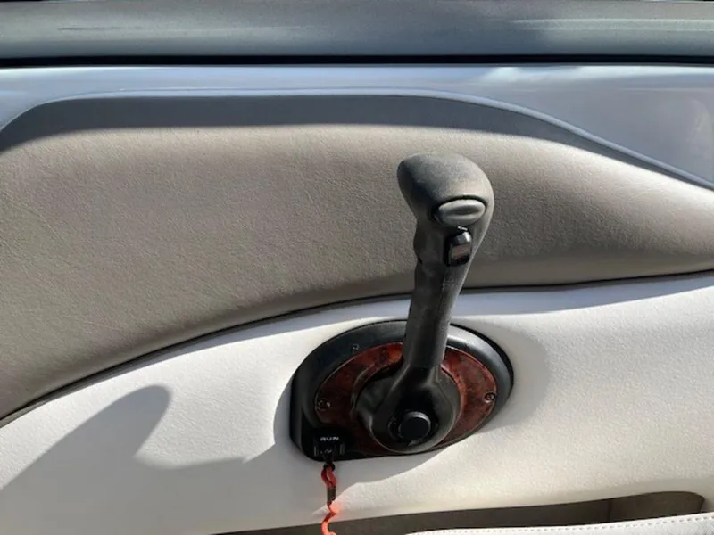 Slide: The Image of Throttle control lever on a 2004 Crownline 230BR boat dashboard. - 7