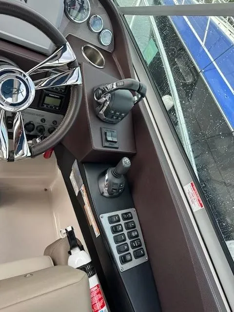 Slide: The Image of 2015 Regal 32 Express boat cockpit with steering wheel and control panel. - 14
