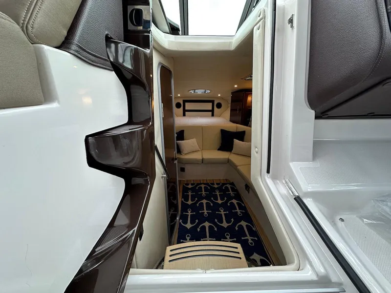 Slide: The Image of Interior view of 2015 Regal 32 Express yacht, featuring a cozy seating area and nautical decor. - 15
