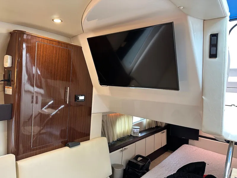Slide: The Image of Interior of 2015 Regal 32 Express yacht with TV and wooden cabinetry. - 17