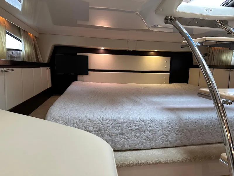 Slide: The Image of Luxurious interior of a 2015 Regal 32 Express yacht with a spacious bed. - 19