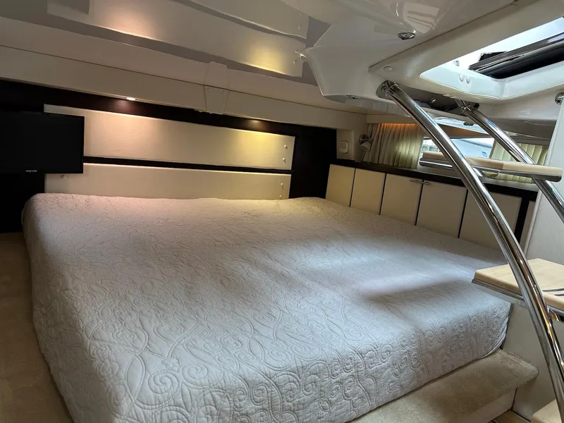 Slide: The Image of Luxurious cabin interior of a 2015 Regal 32 Express yacht with a spacious bed. - 20