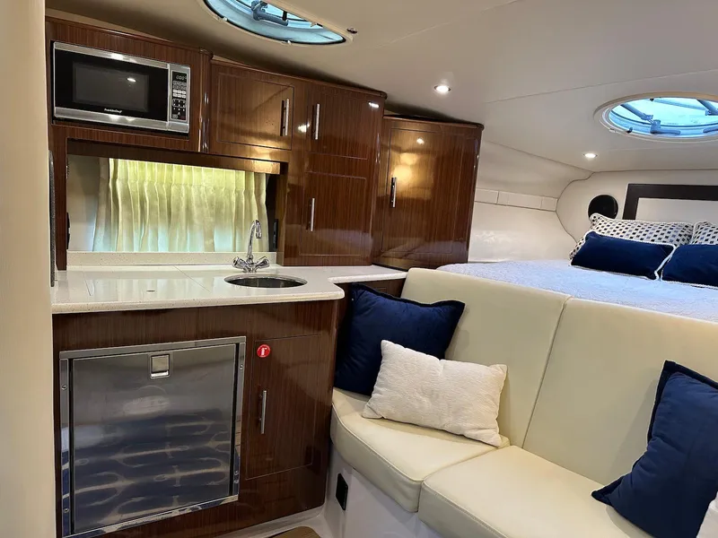 Slide: The Image of Luxurious interior of 2015 Regal 32 Express yacht with kitchenette and seating area. - 22