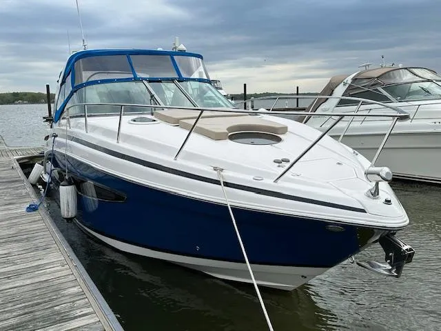 Slide: The Image of 2015 Regal 32 Express boat docked, featuring sleek design and blue accents. - 6