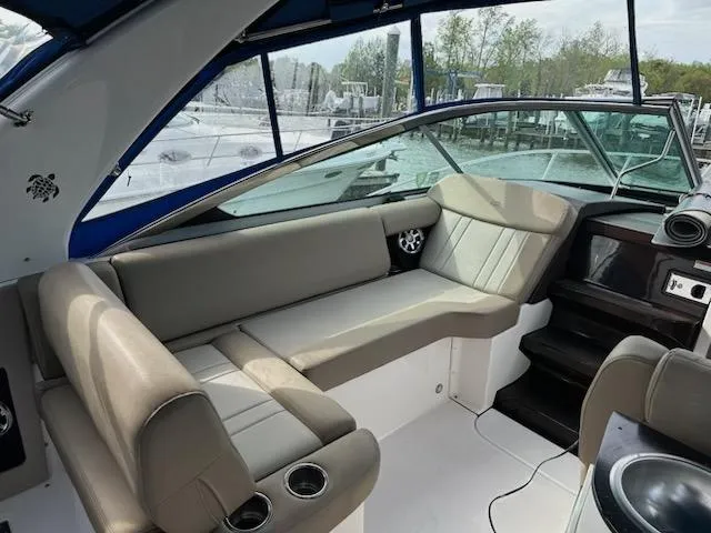 Slide: The Image of 2015 Regal 32 Express boat interior with beige seating and modern design. - 7