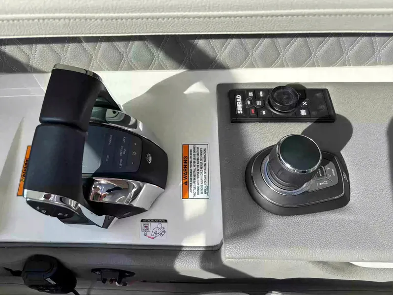 Slide: The Image of Control panel of 2021 Sea Ray SLX 310 OB boat with throttle and joystick. - 12