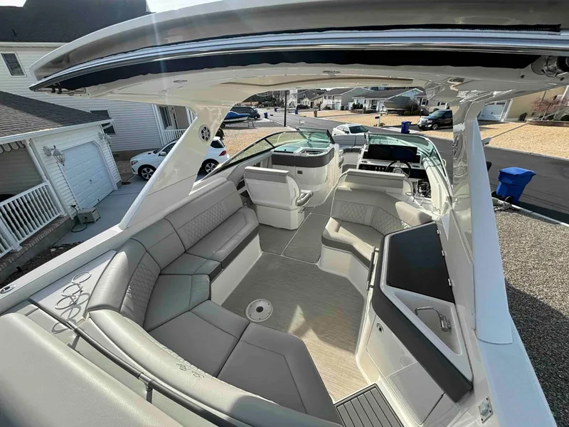 Slide: The Image of 2021 Sea Ray SLX 310 OB boat interior with spacious seating and modern design. - 16