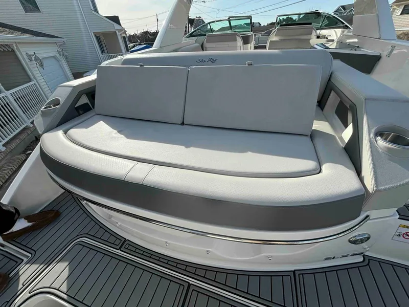 Slide: The Image of 2021 Sea Ray SLX 310 OB boat with spacious rear seating and sleek design. - 20