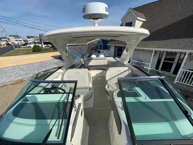 Slide: The Image of 2021 Sea Ray SLX 310 OB boat with open deck and modern design. - 21