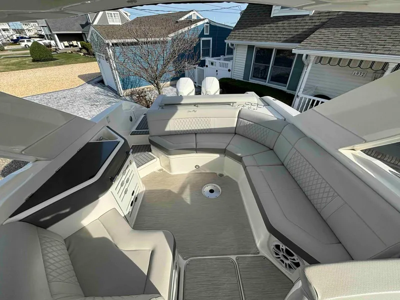 Slide: The Image of 2021 Sea Ray SLX 310 OB boat interior with spacious seating and modern design. - 23