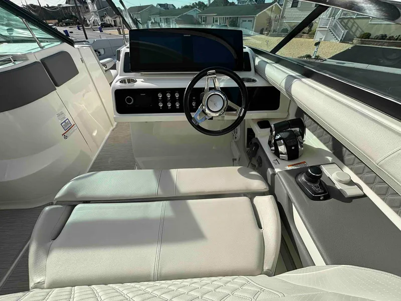 Slide: The Image of 2021 Sea Ray SLX 310 OB boat interior with modern helm and luxurious seating. - 26