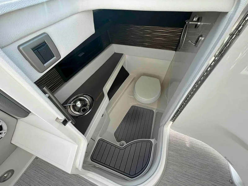 Slide: The Image of 2021 Sea Ray SLX 310 OB boat interior with compact bathroom and modern fixtures. - 27